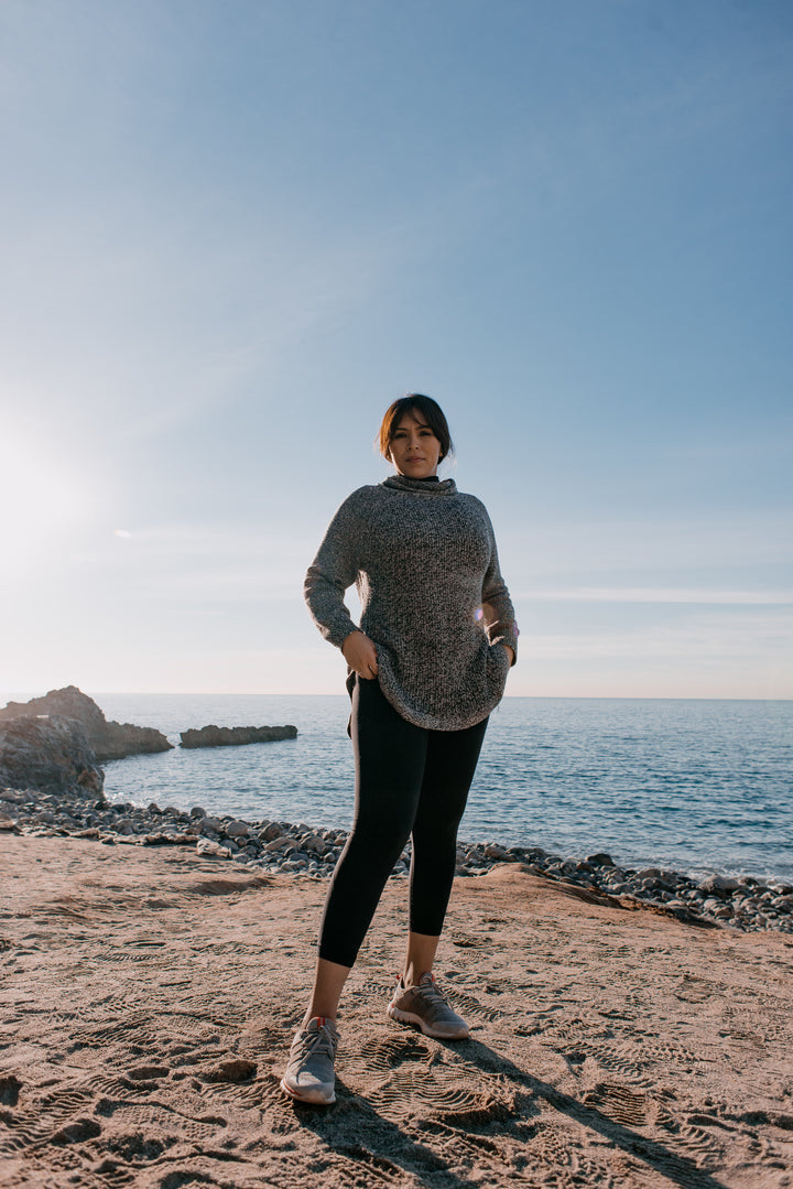 woman-in-sports-clothes-stands-on-a-beach-in-the-morning-light - Odyssey Street
