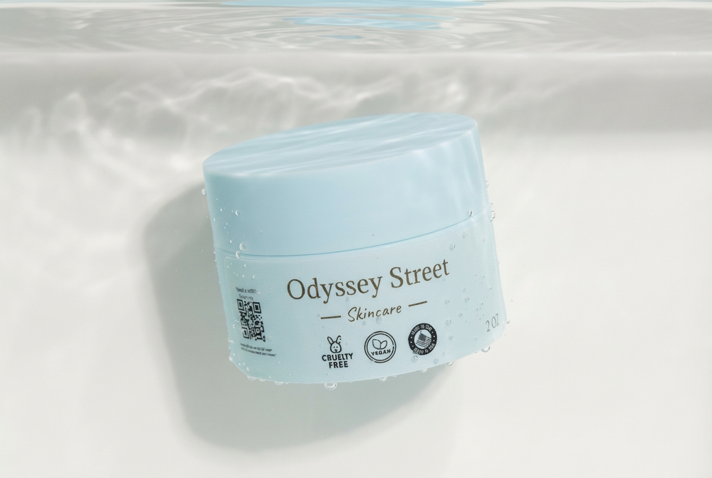 Skincare jar dunked in water with Odyssey Street branding on a light background